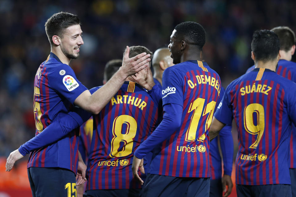 Barcelona defender Clement Lenglet, left, celebrates with teammates scoring the opening goal during a Spanish La Liga soccer match between FC Barcelona and Real Sociedad at the Camp Nou stadium in Barcelona, Spain, Saturday, April 20, 2019. (AP Photo/Joan Monfort)