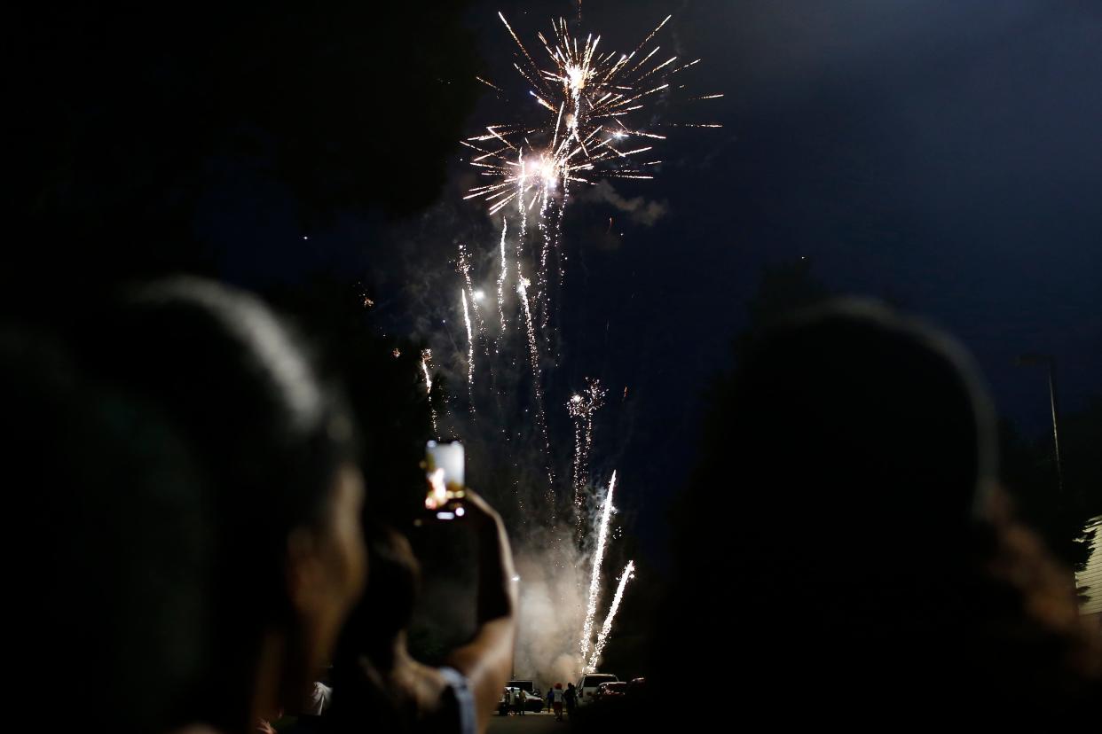Athenians watch fireworks at the "19th is the new 4th" Juneteenth Celebration at Rolling Ridge Apartments on June 19, 2020, in Athens, Ga. The event was the largest Juneteenth celebration in recent Athens history for the holiday that celebrates the end of slavery in the United Sates.