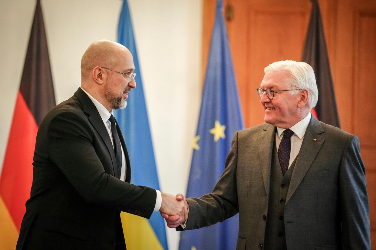 Ukraine’s Prime Minister Denys Shmyhal, left, shakes hands with German President Frank-Walter Steinmeier at Bellevue Palace, in Berlin on Tuesday 24 October. (AP)