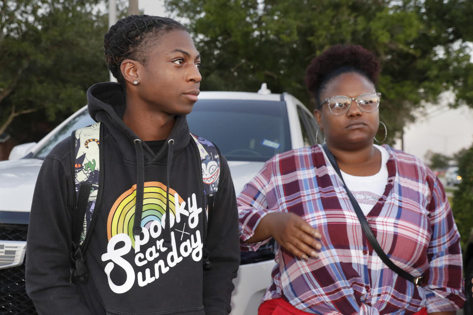 FILE - Darryl George, left, an 18-year-old junior, and his mother Darresha George, talks with reporters before walking into Barbers Hill High School after he served an in-school suspension for not cutting his hair, Sept. 18, 2023, in Mont Belvieu, Texas. Darryl George will be sent to EPIC, an alternative school program, from Oct. 12 through Nov. 29 for “failure to comply” with multiple campus and classroom regulations, the principal said in a Wednesday, Oct. 11, letter provided to The Associated Press by the family. (AP Photo/Michael Wyke, File)