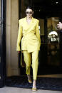 <p>Kendall Jenner certainly wasn’t looking to blend in wearing this neon yellow trouser suit by House of Holland. [Photo: Getty] </p>