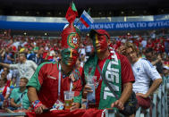 <p>Portu-geezers: Fans of the European champions cover themselves in red and green. (Getty) </p>