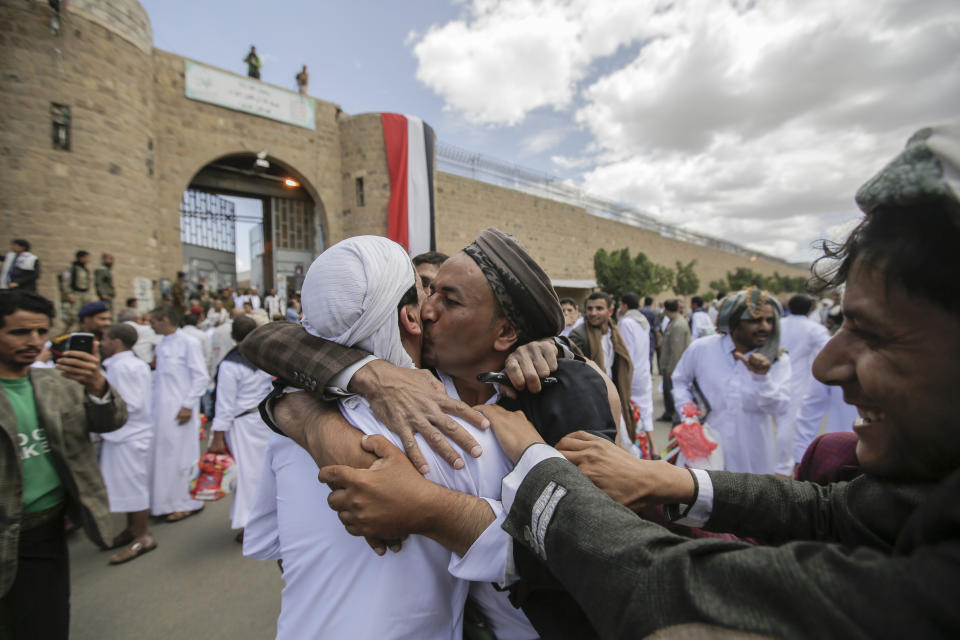 A Yemeni detainee is greeted by his relative and friends after his release from a prison controlled by Houthi rebels, in Sanaa, Yemen, Monday, Sept. 30, 2019. The International Committee of the Red Cross said Monday that Yemen's Houthi rebels have released 290 detainees rounded up over the years and held in several detention centers across the war-torn country. (AP Photo/Hani Mohammed)