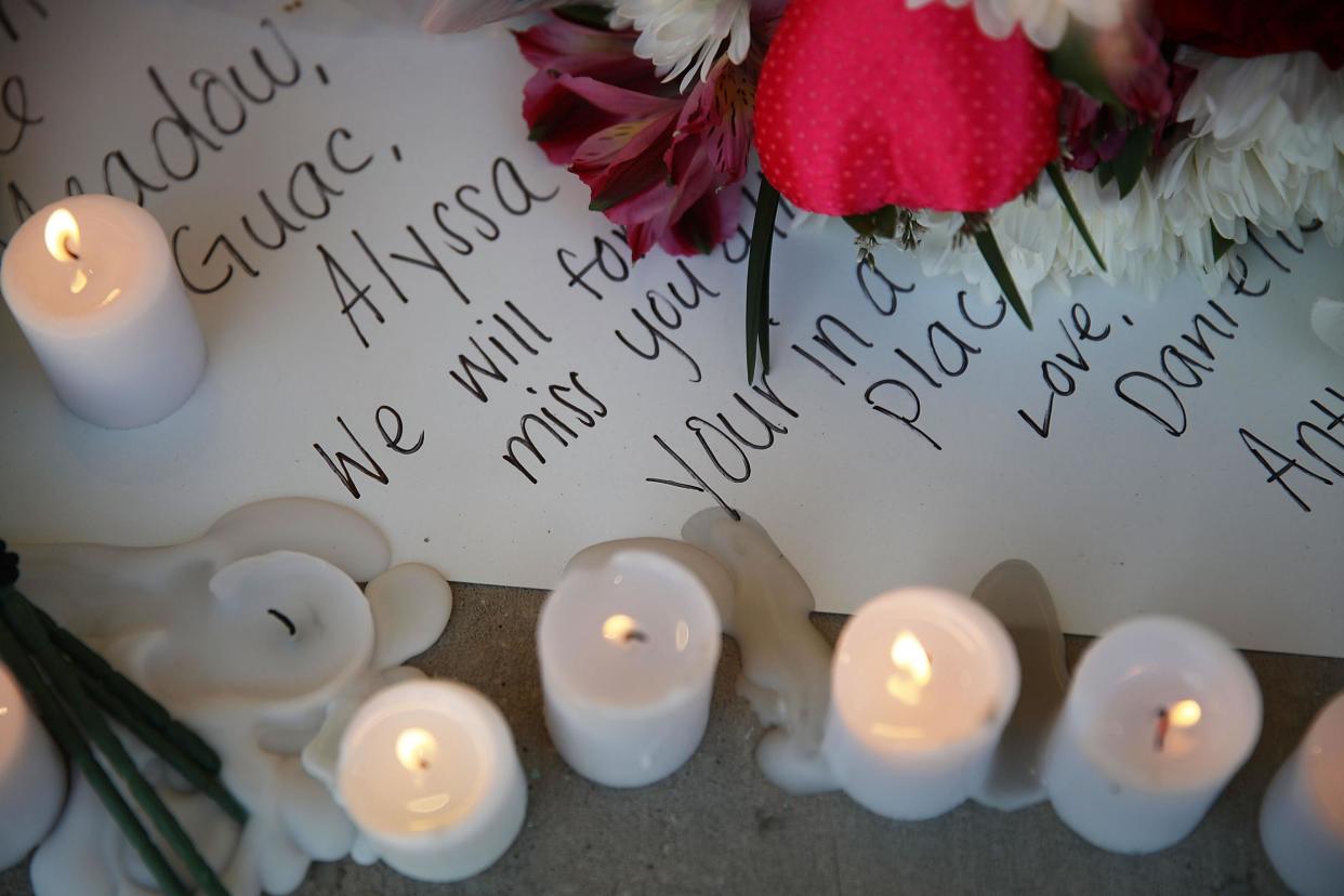 A note is seen left in a memorial setup during a service for the victims of the shooting at Marjory Stoneman Douglas High Schoo: Joe Raedle/Getty Images