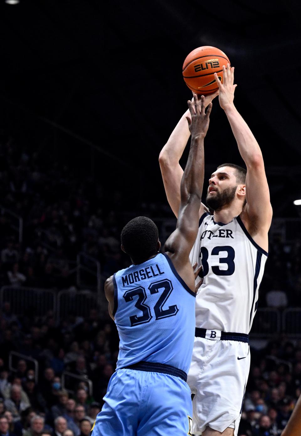 Feb 12, 2022; Indianapolis, Indiana, USA;  Butler Bulldogs forward Bryce Golden (33) shoots the ball over Marquette Golden Eagles guard Darryl Morsell (32) during the first half at Hinkle Fieldhouse. Mandatory Credit: Marc Lebryk-USA TODAY Sports