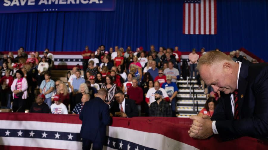 Michigan state Representative Matt Maddock bows his head during a prayer.