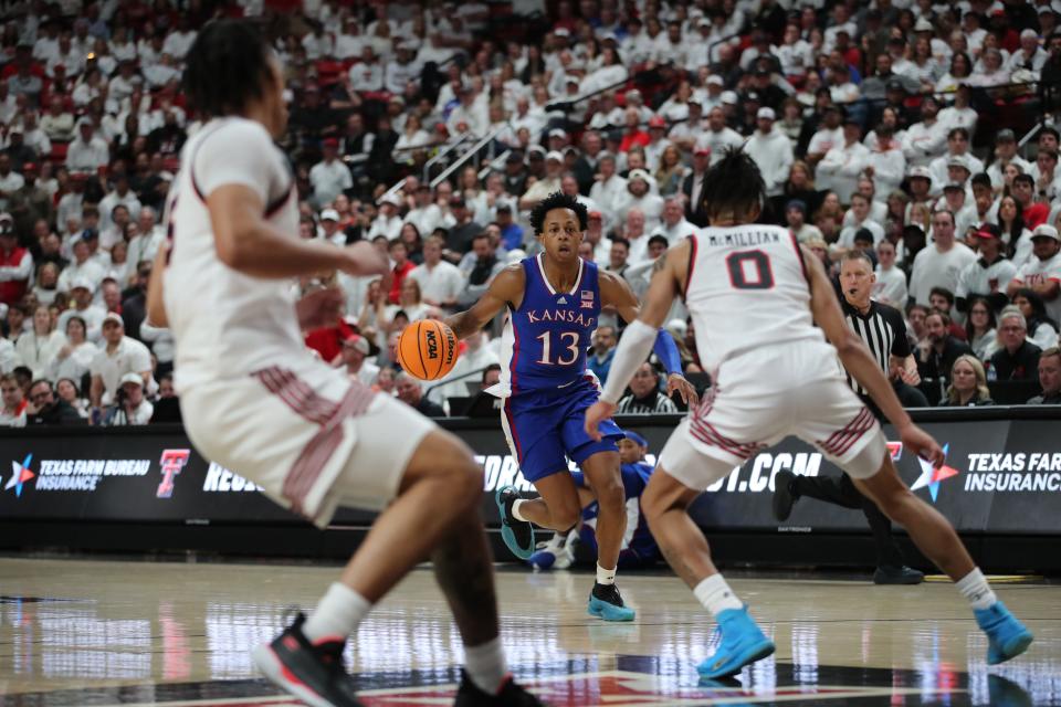 Kansas guard Elmarko Jackson (13) brings the ball up court against the Texas Tech defense during the second half at United Supermarkets Arena.