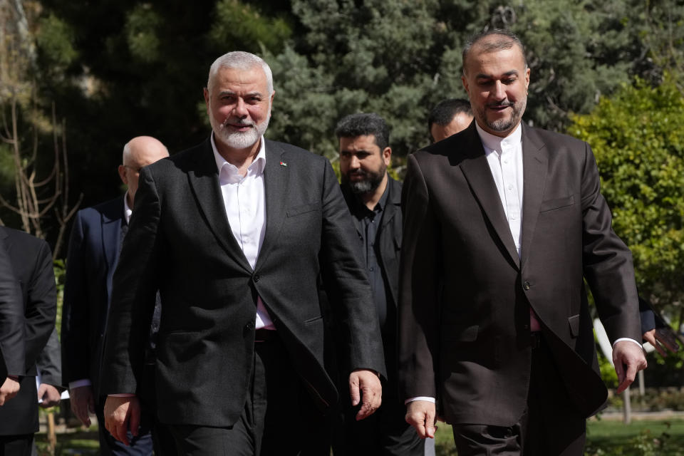 Hamas chief Ismail Haniyeh, left, is welcomed by Iranian Foreign Minister Hossein Amirabdollahian for their meeting in Tehran, Iran, Tuesday, March 26, 2024. (AP Photo/Vahid Salemi)