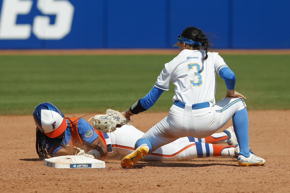 Florida outfielder Cheyenne Lindsey (2) is slides in safe at second base before UCLA infielder Briana Perez (3) can make the tag during the fifth inning of an NCAA softball Women's College World Series game on Sunday, June 5, 2022, in Oklahoma City. (AP Photo/Alonzo Adams)