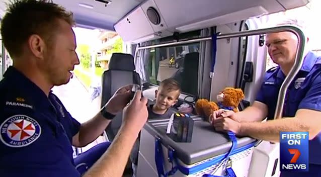 Lawson Lowe with the two paramedics who helped change his memory of ambulances following a horrific accident. Photo: 7 News