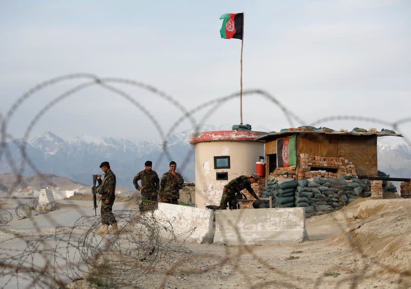 Afghan National Army (ANA) soldiers stand guard at a checkpoint outside Bagram prison, north of Kabul, Afghanistan