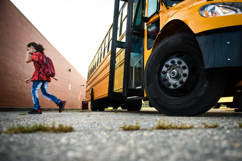 A student steps off the school bus at Anne Chesnutt Middle School on Monday, July 18, 2022.