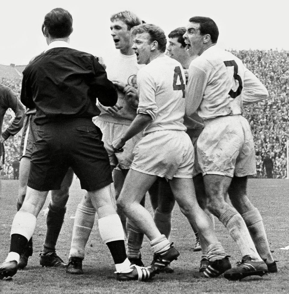 Referee Ken Burns, who has just disallowed a Leeds equaliser against Chelsea in their 1966-67 FA Cup semi-final at Villa Park, is assailed by Bell and his teammates, l-r, Jimmy Greenhoff, Billy Bremner and Johnny Giles - Patrick Larkin/Daily Mail/Shutterstock