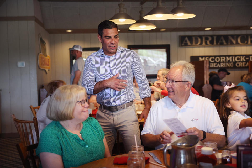 Republican presidential candidate Miami Mayor Francis Suarez greets diners at the Machine Shed restaurant after having breakfast with his family and members of his campaign staff on July 29, 2023 in Urbandale, Iowa.  / Credit: Scott Olson / Getty Images