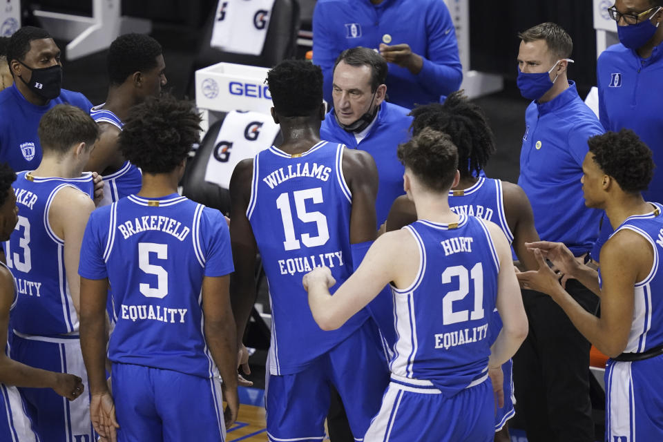 Duke head coach Mike Krzyzewski, top, talks to his team during the first half of an NCAA college basketball game against Louisville in the second round of the Atlantic Coast Conference tournament in Greensboro, N.C., Wednesday, March 10, 2021. Duke has pulled out of the Atlantic Coast Conference Tournament and ended its season after a positive coronavirus test and the resulting quarantining and contact tracing. The ACC announced that the Blue Devils’ quarterfinal game with Florida State scheduled for Thursday night has been canceled. (AP Photo/Gerry Broome)