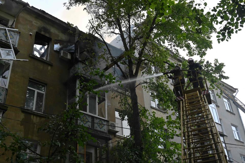 Rescuers put out a fire in a five-storey residential building after drones attacks killed two and wounded 19 in eastern Ukrainian city of Sumy (AFP via Getty Images)
