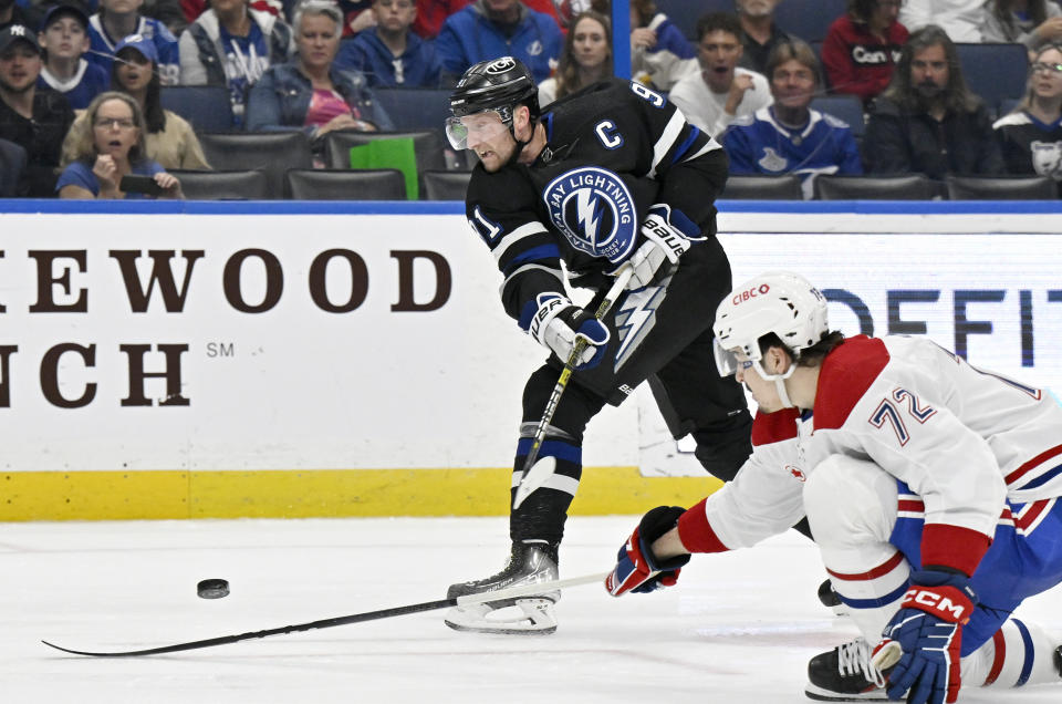 Tampa Bay Lightning center Steven Stamkos (91) shoots against Montreal Canadiens defenseman Arber Xhekaj (72) during the second period of an NHL hockey game Saturday, March 2, 2024, in Tampa, Fla. (AP Photo/Jason Behnken)