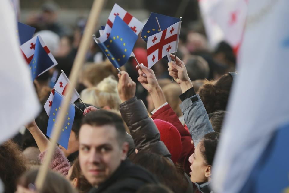 Georgians wave EU and national flags gather to celebrate Georgia's EU candidacy at Liberty Square in Tbilisi, Georgia, on Friday, Dec. 15, 2023. Several thousand people attend a march in support of Georgia's EU candidacy. European Union flags waved across Georgia Friday after the European Council took a step forward along the long road towards granting Georgia and Moldova as EU membership. (AP Photo/Zurab Tsertsvadze)