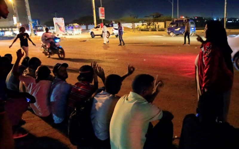 Civilians gather near the area where gunmen opened fire outside buildings used by Sudan's National Intelligence and Security Service in Khartoum