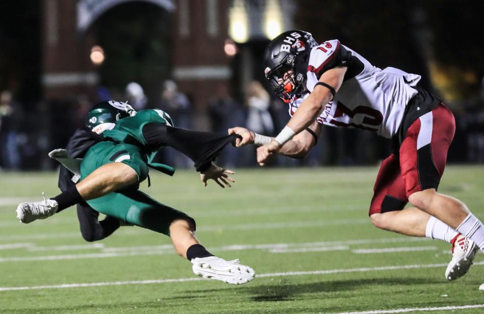 Ballard's Gavin Willis grabs Trinity quarterback Brady Willis during the game Friday night. The Rocks would lead 24-0 at halftime. Nov. 12, 2021