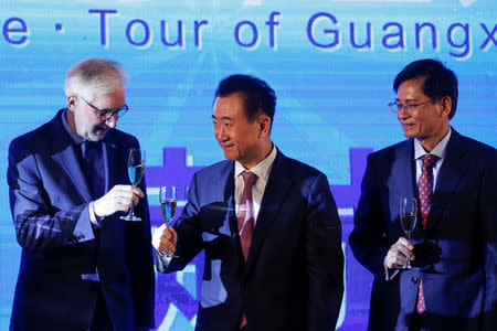 Wanda Group Chairman Wang Jianlin (R), President of the Union Cycliste Internationale (UCI) Brian Cookson (L) and Guangxi autonomous region official Lan Tianli attend a signing ceremony for a China hosted Union Cycliste Internationale (UCI) world tour cycling race in Beijing, China, December 1, 2016. REUTERS/Thomas Peter