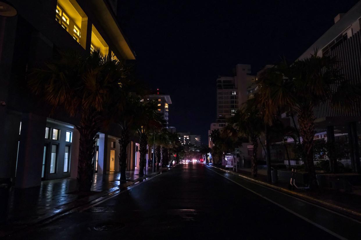 Street lamps are out on a street in the Condado community of Santurce in San Juan, Puerto Rico, on September 19, 2022, after the passage of Hurricane Fiona.