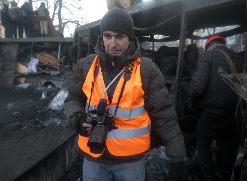 In this photo taken Monday, Jan. 27, 2014, journalist Ihor Medelyan, 32, talks to the Associated Press in an interview near barricades in central Kiev, the site of violent clashes between protesters and police. Medelyan quit the government-owned First National channel after the government violently dispersed a small peaceful protest rally and after his channel refused to objectively report on the event. (AP Photo/Sergei Chuzavkov)