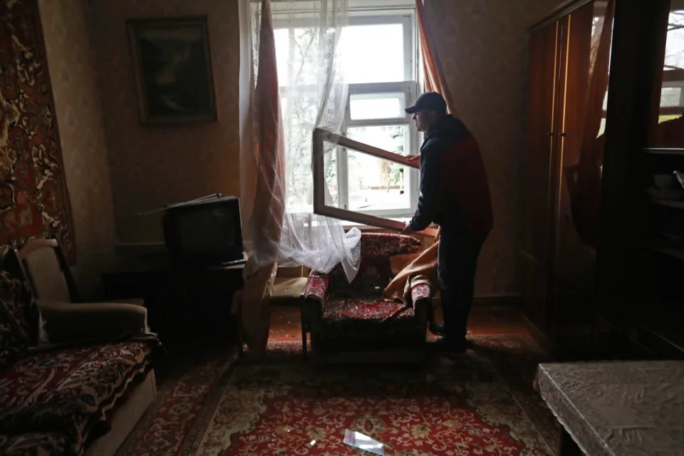 A man repairs a window.