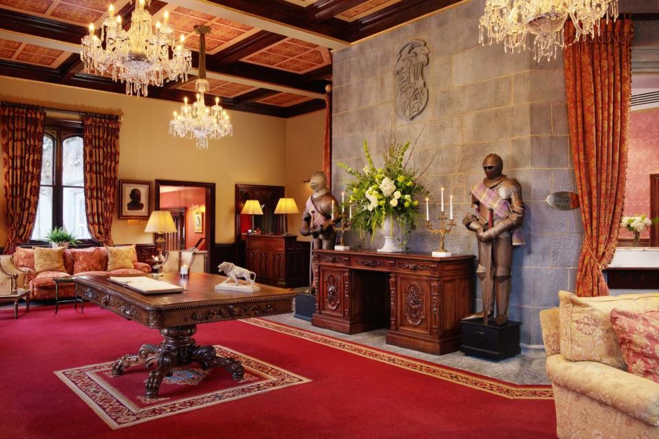 Two suits of armor guard the reception area at the Dromoland Castle