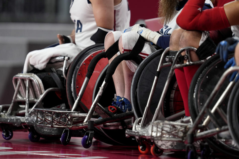 The wheelchairs of U.S. team members are seen during their Wheelchair Rugby pool match match against Canada at the Tokyo 2020 Paralympic Games, Thursday, Aug. 26, 2021, in Tokyo, Japan. There are 4,403 Paralympic athletes competing in Tokyo, each with unique differences that have to be classified. Lines have to be draw, in the quest for fairness, to group similar impairments, or impairments that yield similar results. (AP Photo/Shuji Kajiyama)