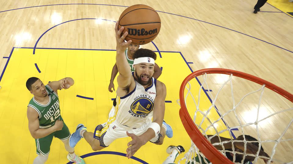 Thompson drives to the basket against the Boston Celtics during the 2022 NBA Finals. Golden State went on to win the series in six games. - Jed Jacobsohn/AP