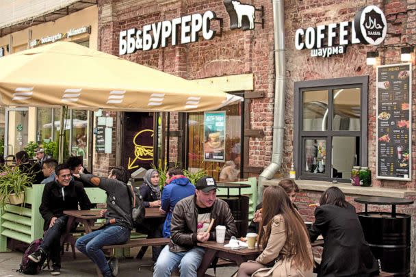 PHOTO: Sanctions have isolated Russians from the outside world. In this photo, people dine at the BB & Burgers, a Russian-owned American-styled chain restaurant. (SOPA Images/LightRocket via Getty Images, FILE)