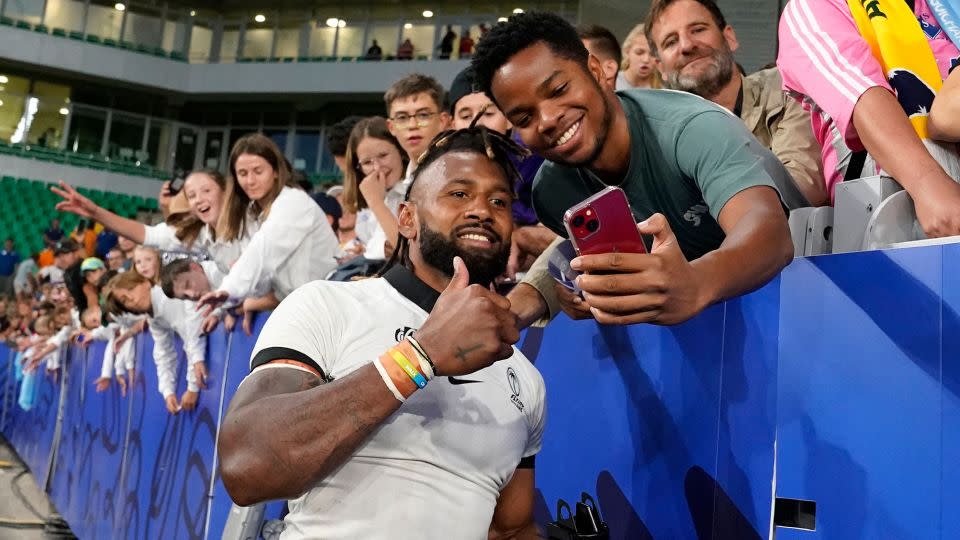 Captain Waisea Nayacalevu celebrates victory against Australia with a fan. - Francis Bompard/AFP/Getty Images