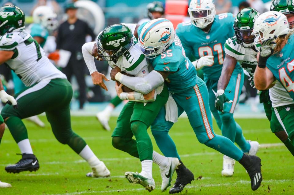 Dolphins outside linebacker Jerome Baker sacks Jets quarterback Zach Wilson last December at Hard Rock Stadium.