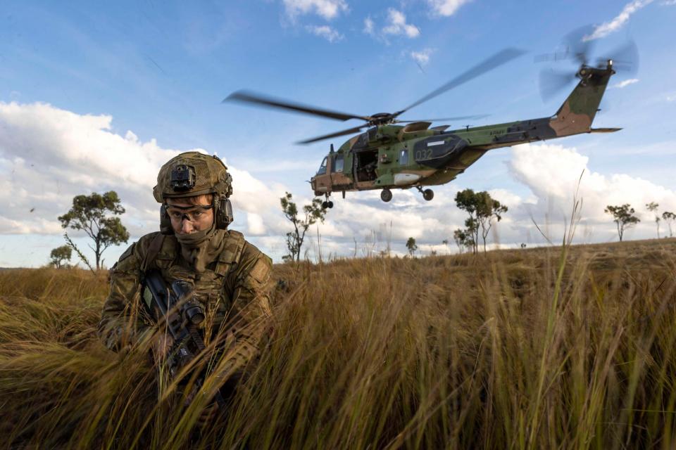 An Australian soldier deploys from a 5th Aviation Regiment NH-90 Tactical Transport Helicopter into Townsville Field Training Area during Exercise Chau Pha in June 2023 in what would have been amongst the final flight operations of the type. <em>Commonwealth of Australia, Department of Defense</em>