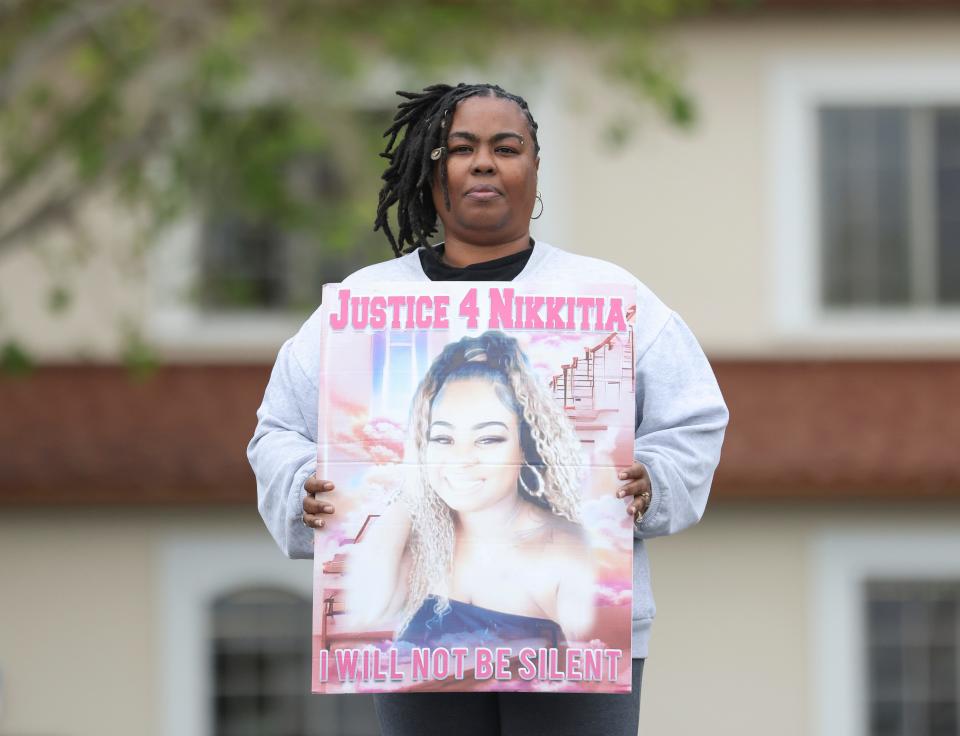 Nikkiti White, of Fort Pierce, holds a poster of her daughter Nikkitia Bryant that says, "Justice 4 Nikkitia, I Will Not be Silent" Thursday, Jan. 11, 2024, in downtown Fort Pierce. Bryant, 29, was fatally injured in a mass shooting during a Martin Luther King Jr. Day celebration event on Jan. 16, 2023, at Ilous Ellis Park in Fort Pierce. White said she has custody of her granddaughter Ni'Dazia William. Ni'Dazia was with her mom during the gunfire that also wounded seven others.