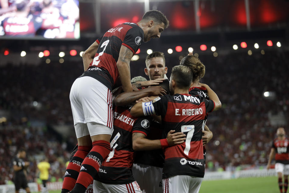 Soccer players of Brazil's Flamengo celebrate their side's third goal scored by Bruno Henrique against Ecuador's Barcelona during a Copa Libertadores soccer match in Rio de Janeiro, Brazil, Wednesday, March 11, 2020. (AP Photo/Silvia Izquierdo)