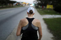 Dirt covers the back of U.S. Army Sgt. Rose Stromberg after she crawled into her storage unit, which was flooded in the aftermath of Hurricane Florence, to retrieve an American flag adorned with the names of those killed in the 9/11 terrorist attacks, in Spring Lake, N.C., Wednesday, Sept. 19, 2018. (AP Photo/David Goldman)