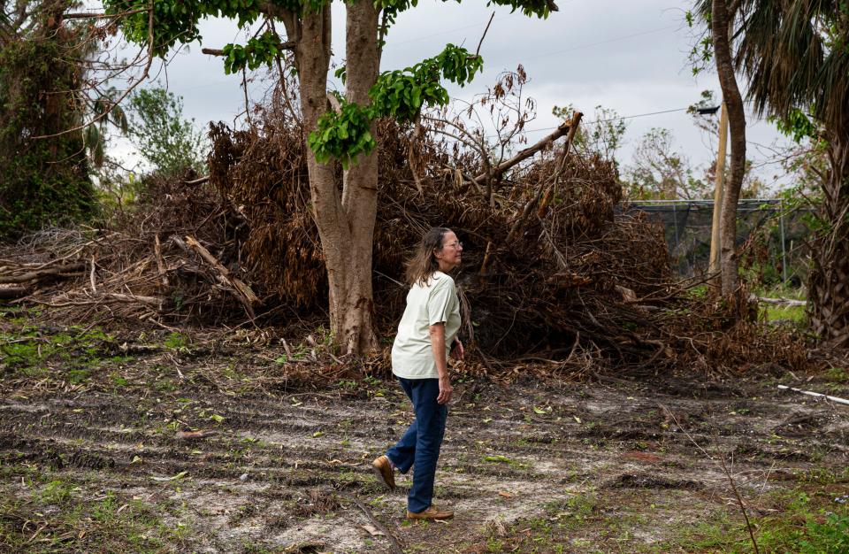 Donna Schneider, owner of Pine Island Tropicals surveys her property that was wiped out Hurricane Ian.