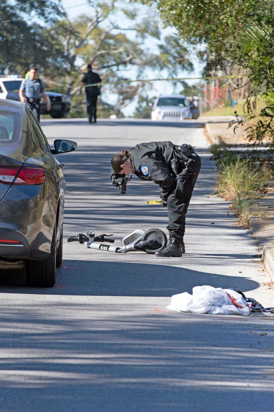 Pensacola police on Tuesday investigate the scene near G and Gonzalez streets where a scooter rider was struck by a car after the rider ran a stop sign, according to authorities.