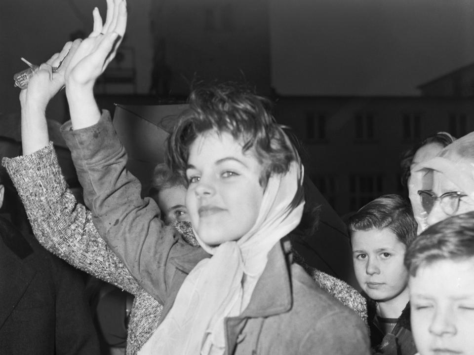 Elvis Presley's girlfriend Priscilla Beaulieu waves goodbye to Elvis as he departs from Rhine-Main air base February 2, 1960