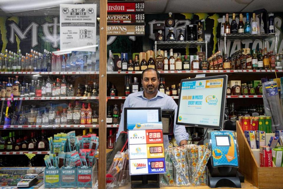 Jas Hundal, owner of Natomas Wine & Spirits, stands behind the counter at his Sacramento store on Wednesday, Aug. 16, 2023, just before he closed the shop for two hours to protest Senate Bill 553. The bill would prohibit employers from maintaining policies that require rank-and-file, non-security personnel to confront suspected active shoplifters.