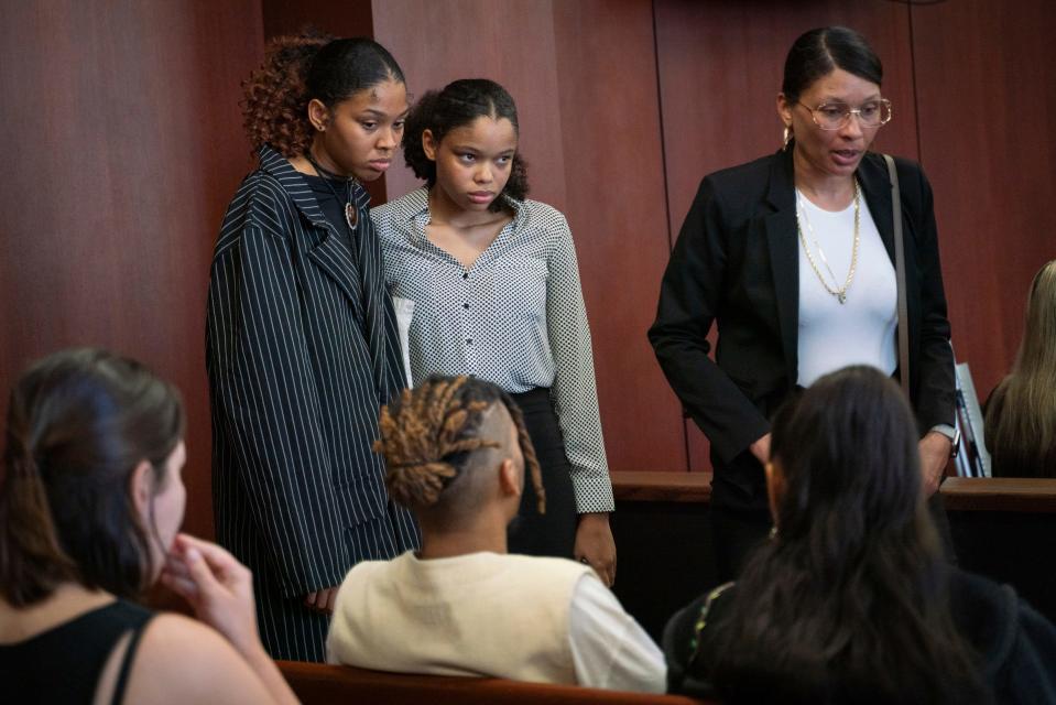 Aretha Franklin's granddaughters Victorie Franklin, 24, left, and Grace Franklin, 17, stand with their mother Kafi Franklin, 48 after closing arguments on the second day of a jury trial over Aretha Franklin's wills at Oakland County Probate Court in Pontiac on Tuesday, July 11, 2023. The trial will decide which of the two handwritten wills should prevail and how assets will be distributed among Franklin's sons and other potential heirs.