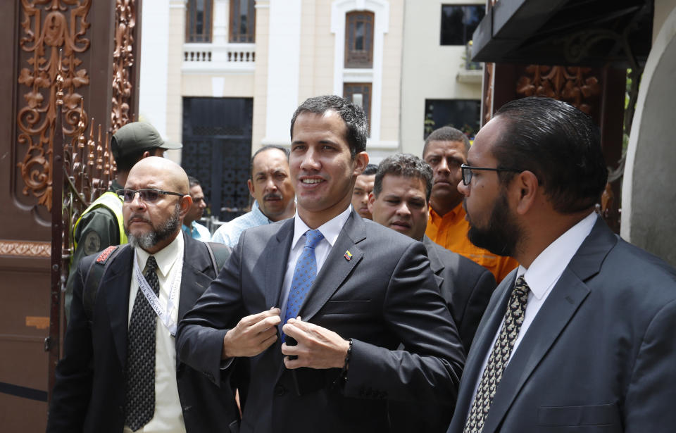 National Assembly President Juan Guaido, who declared himself interim president of Venezuela, adjusts his blazer as he arrives to lead a session of the opposition-controlled assembly in Caracas, Venezuela, Monday, March 11, 2019. The U.S.-backed leader of the National Assembly has blamed the blackouts that began Thursday on alleged government corruption and mismanagement. (AP Photo/Eduardo Verdugo)