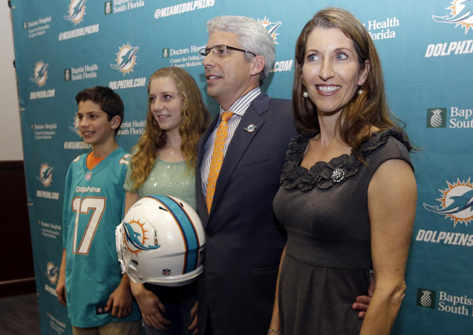 Dennis Hickey, new general manager for the Miami Dolphins football team, second from right, poses with his wife Stephanie, right, son Barrett, left, and daughter Breanna, second from left, after being introduced during a news conference, Tuesday, Jan. 28, 2014, in Davie, Fla. (AP Photo/Lynne Sladky)