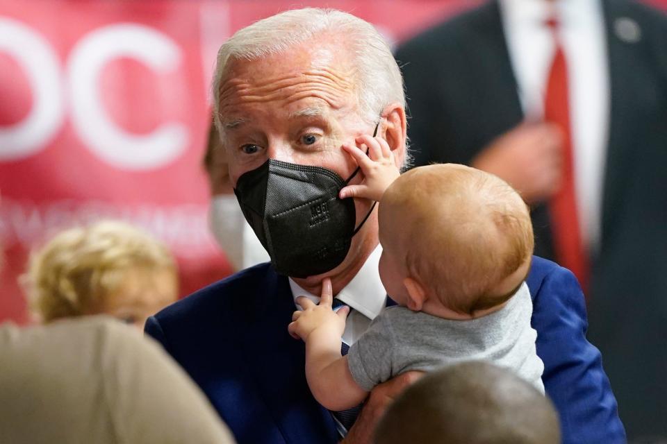 President Joe Biden holds a baby as he visits a COVID-19 vaccination clinic at the Church of the Holy Communion Tuesday, June 21, 2022, in Washington.