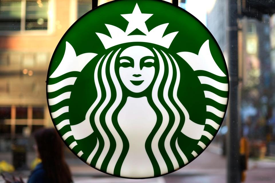 The Starbucks logo is displayed in the window of a downtown Pittsburgh Starbucks.