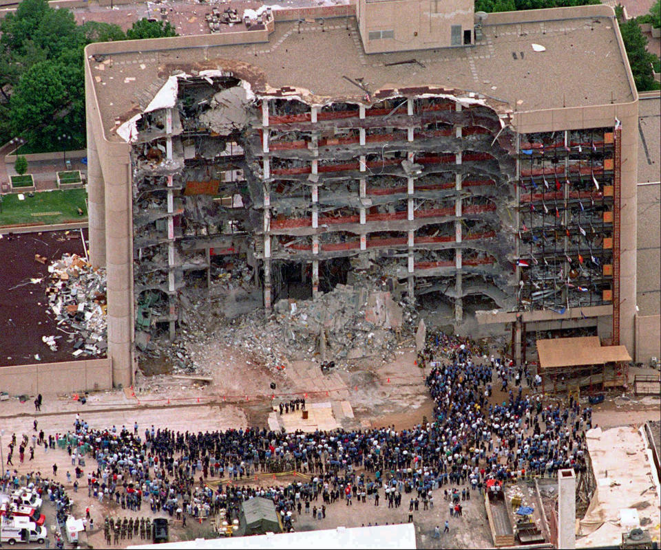 A large group of search and rescue crew attends a memorial service in front of the Alfred P. Murrah Federal Building in Oklahoma City on May 5, 1995. The blast killed 168 people _ including 19 children _ injured hundreds more and caused hundreds of millions of dollars in damage to structures and vehicles in the downtown area.  (Photo: Bill Waugh/AP)