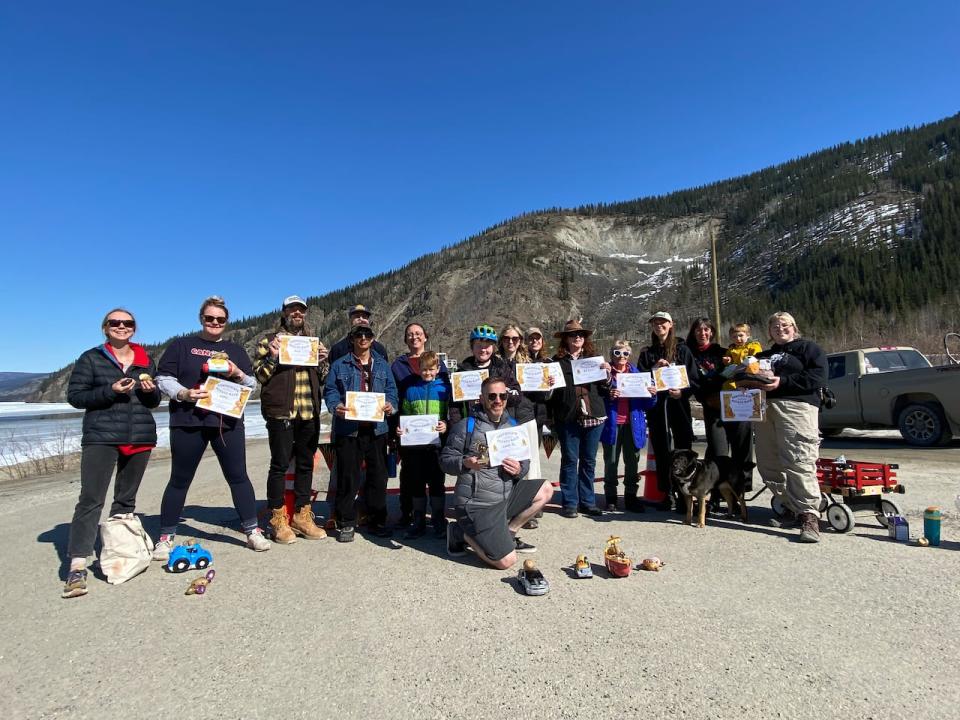 A group of people who race potatoes for the Dawson City, Yukon potato race. Only one was crowned champion but everyone left feeling like winners.