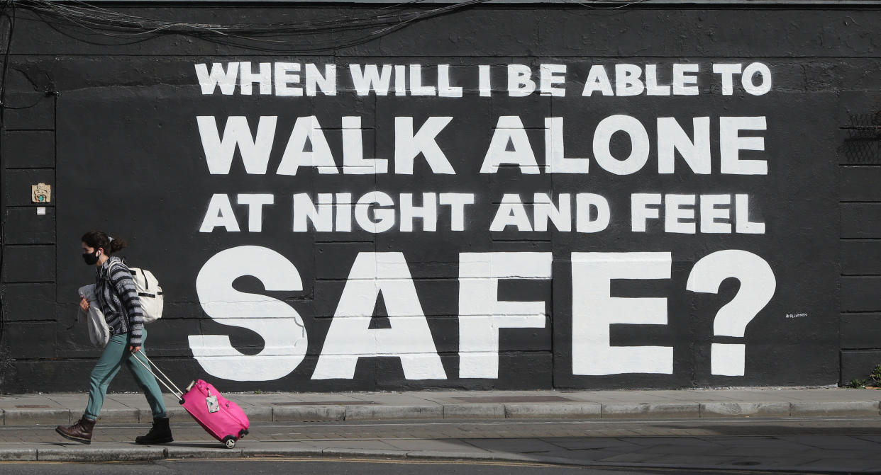 A member of the public walks past the latest mural by Irish artist Emmalene Blake in Dublin's city centre. The inscription 'When will I be able to walk alone at night and feel safe?' relates to violence against women in the wake of the death of Sarah Everard. Picture date: Monday March 29, 2021. (Photo by Niall Carson/PA Images via Getty Images)